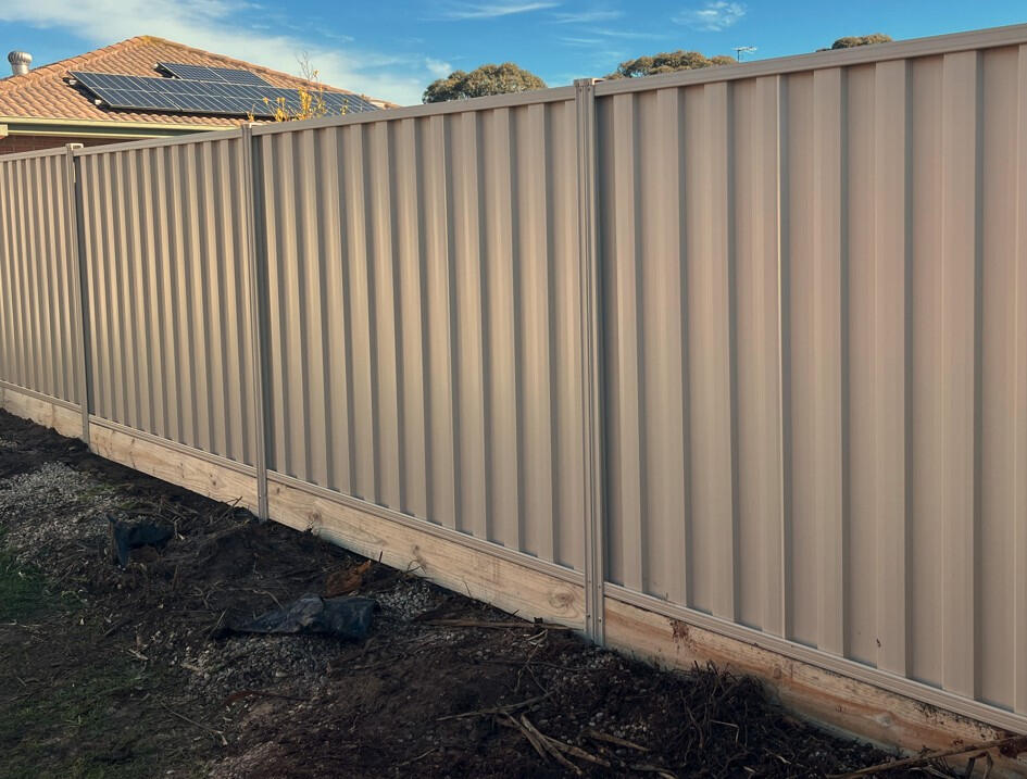 Colorbond fence Paperbark with timber sleepers installed in Pakenham